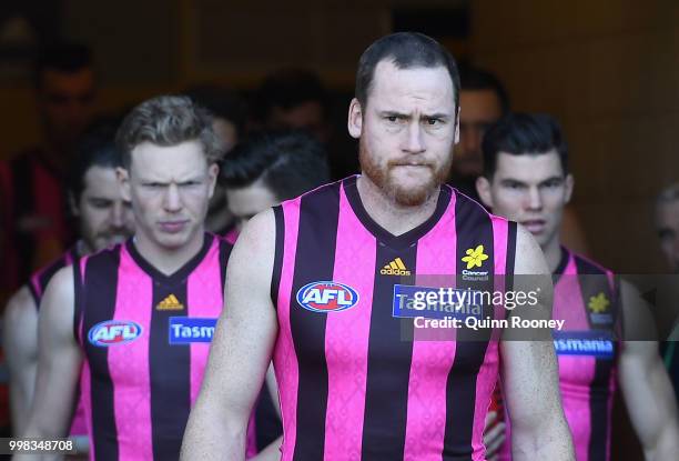 Jarryd Roughead of the Hawks leads his team out onto the field during the round 17 AFL match between the Hawthorn Hawks and the Brisbane Lions at...