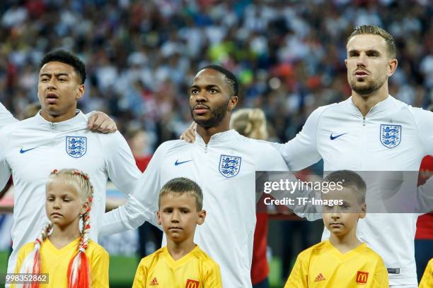 Jesse Lingard of England, Raheem Sterling of England and Jordan Henderson of England look on prior to the 2018 FIFA World Cup Russia Semi Final match...