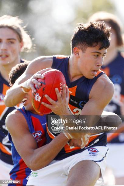 Ismail Moussa of the Cannons is tackled during the round 12 TAC Cup match between Oakleigh and Calder at Warrawee Park on July 14, 2018 in Melbourne,...