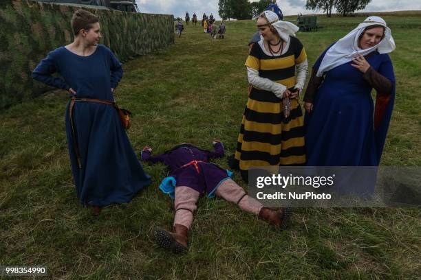 Man lying on the grass is seen in Grunwald, Poland on 13 July 2018 Battle of Grunwald reenactment participants take part in the last rehearsal...