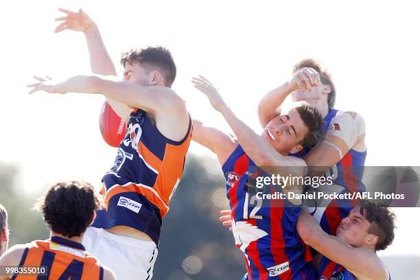 Mitchell Podhajski of the Cannons and Noah Answerth of the Chargers contest the ba;; during the round 12 TAC Cup match between Oakleigh and Calder at...