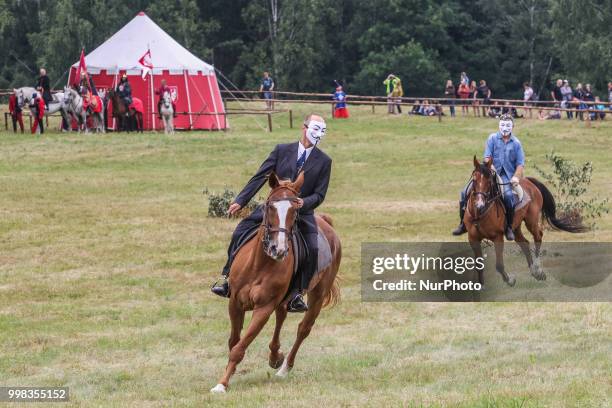 Man riding a horse wearing Guy Fawkes mask is seen in Grunwald, Poland on 13 July 2018 Battle of Grunwald reenactment participants take part in the...