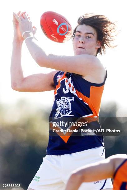 Brodie Newman of the Cannons attempts to mark the ball during the round 12 TAC Cup match between Oakleigh and Calder at Warrawee Park on July 14,...
