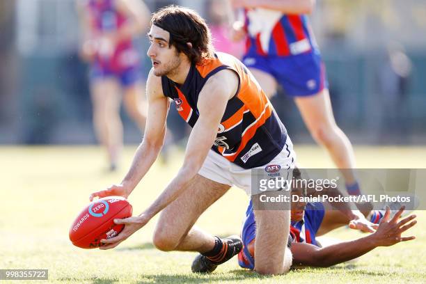 Daniel Hanna of the Cannons handpasses the ball during the round 12 TAC Cup match between Oakleigh and Calder at Warrawee Park on July 14, 2018 in...