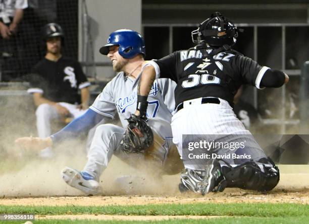 Hunter Dozier of the Kansas City Royals is safe at home as Omar Narvaez of the Chicago White Sox makes a late tag during the eighth inning on July...