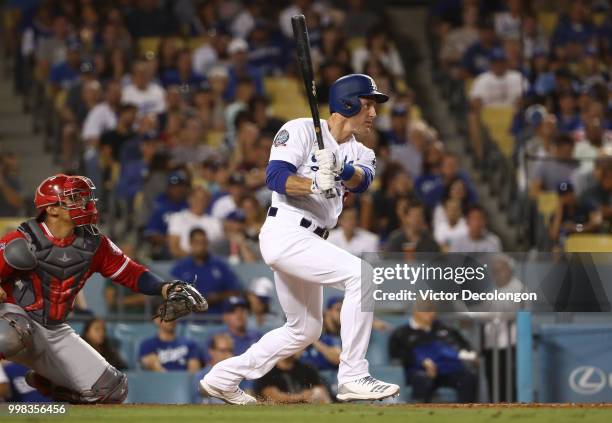 Chase Utley of the Los Angeles Dodgers hits a single to right field in the fifth inning during the MLB game against the Los Angeles Angels of Anaheim...