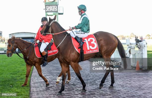 Michael Walker returns to the mounting yard on Sharpness after winning the Ladbrokes Odds Boost Exotics Handicap ,at Caulfield Racecourse on July 14,...