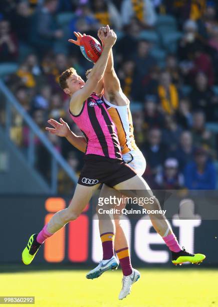 Tim O'Brien of the Hawks marks infront of Tom Cutler of the Lions during the round 17 AFL match between the Hawthorn Hawks and the Brisbane Lions at...