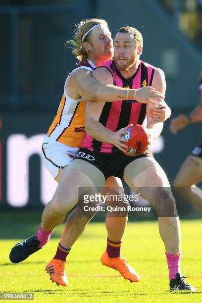 Jarryd Roughead of the Hawks is tackled by Daniel Rich of the Lions during the round 17 AFL match between the Hawthorn Hawks and the Brisbane Lions...