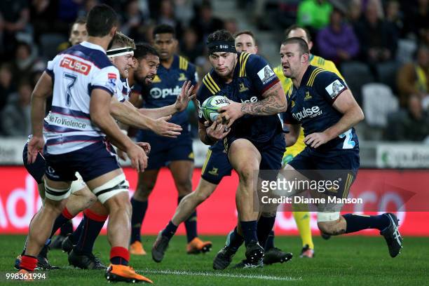 Tyrel Lomax of the Highlanders runs the ball during the round 19 Super Rugby match between the Highlanders and the Rebels at Forsyth Barr Stadium on...