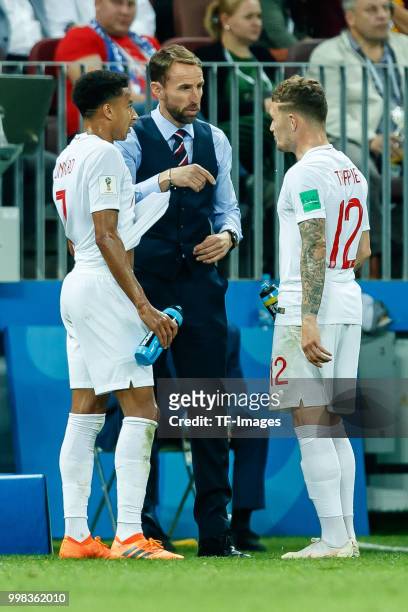 Head coach Gareth Southgate of England speaks with Jesse Lingard of England and Kieran Trippier of England during the 2018 FIFA World Cup Russia Semi...