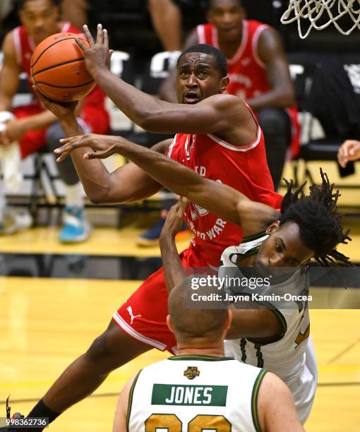 Jamarious Anderson of the Fort Hood Wounded Warriors is fouled by Christopher Clarke of the Utah Valor as he goes for a basket in the West Regional...