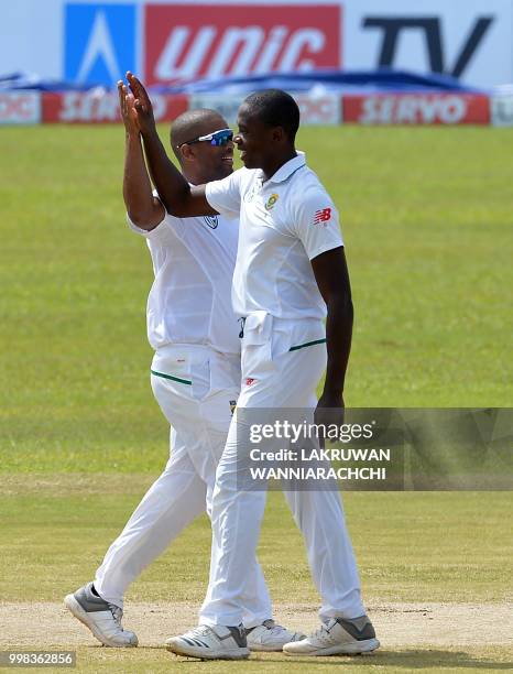 South Africa's Kagiso Rabada celebrates with his teammate Vernon Philander after he dismissed Sri Lanka's Roshen Silva during the third day of the...