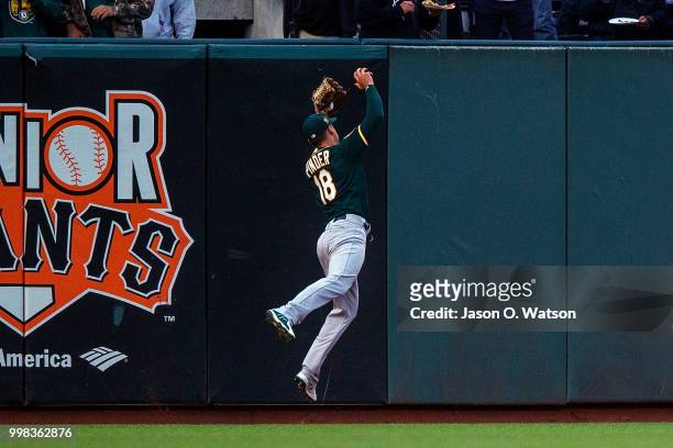 Chad Pinder of the Oakland Athletics catches a fly ball hit off the bat of Madison Bumgarner of the San Francisco Giants during the third inning at...
