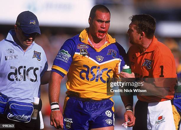 Alex Chan for Parramatta is helped by team trainers after being injured during the NRL fourth qualifying final match played between the Parramatta...