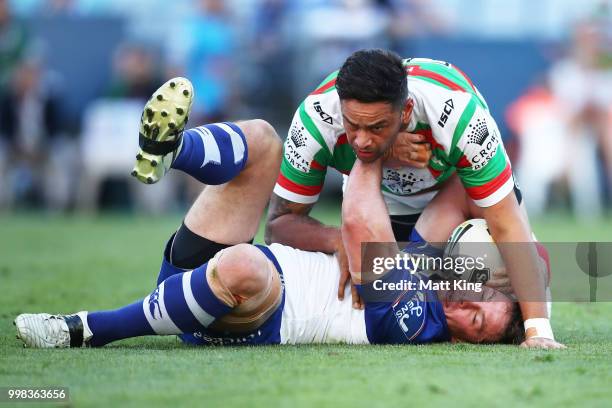 Josh Jackson of the Bulldogs is tackled by John Sutton of the Rabbitohs during the round 18 NRL match between the Canterbury Bulldogs and the South...