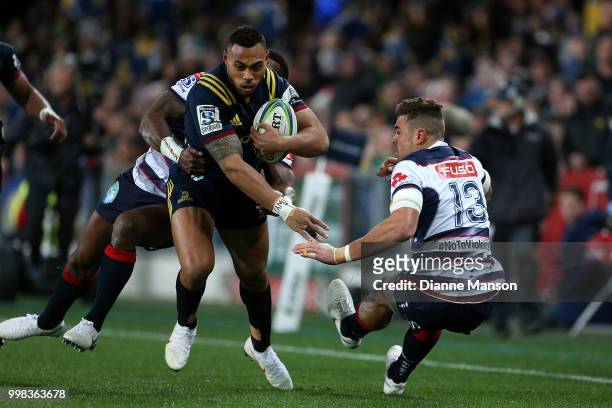 Tevita Li of the Highlanders fends off Tom English of the Rebels during the round 19 Super Rugby match between the Highlanders and the Rebels at...