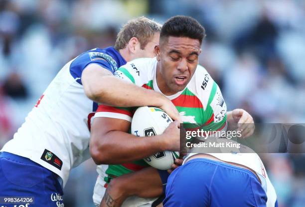 Tevita Tatola of the Rabbitohs is tackled during the round 18 NRL match between the Canterbury Bulldogs and the South Sydney Rabbitohs at ANZ Stadium...