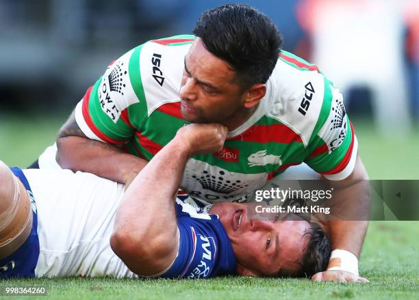 Josh Jackson of the Bulldogs is tackled by John Sutton of the Rabbitohs during the round 18 NRL match between the Canterbury Bulldogs and the South...