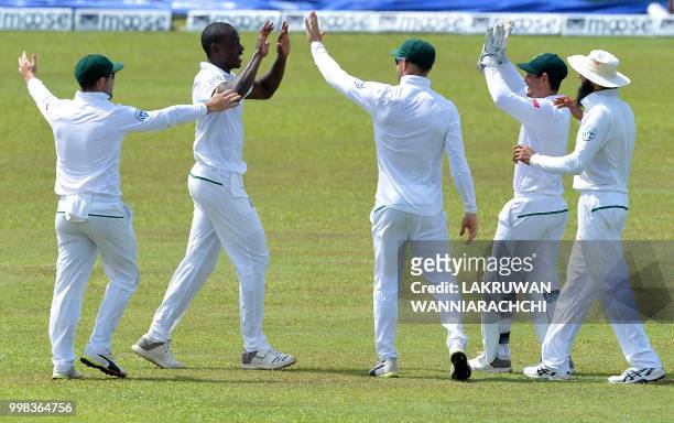 South Africa's Kagiso Rabada celebrates with his teammates after he dismissed Sri Lanka's Niroshan Dickwella during the third day of the opening Test...