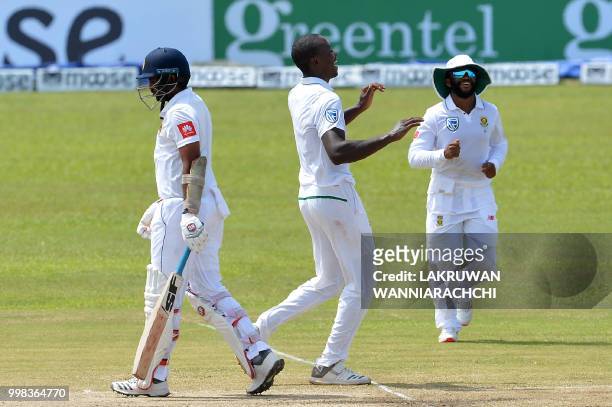 South Africa's Kagiso Rabada celebrates with his teammates after he dismissed Sri Lanka's Dilruwan Perera during the third day of the opening Test...