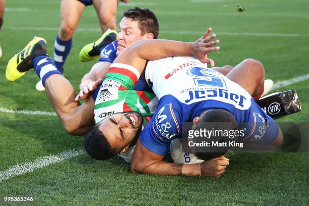 Robert Jennings of the Rabbitohs is tackled in to touch by Reimis Smith of the Bulldogs during the round 18 NRL match between the Canterbury Bulldogs...