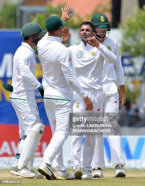 South Africa's Keshav Maharaj celebrates with his teammates after he dismissed Sri Lanka's Angelo Mathews during the third day of the opening Test...