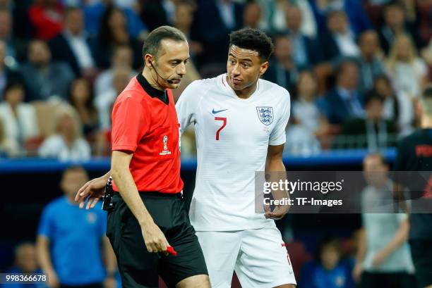 Referee Cueneyt Cakir speaks with Jesse Lingard of England during the 2018 FIFA World Cup Russia Semi Final match between Croatia and England at...