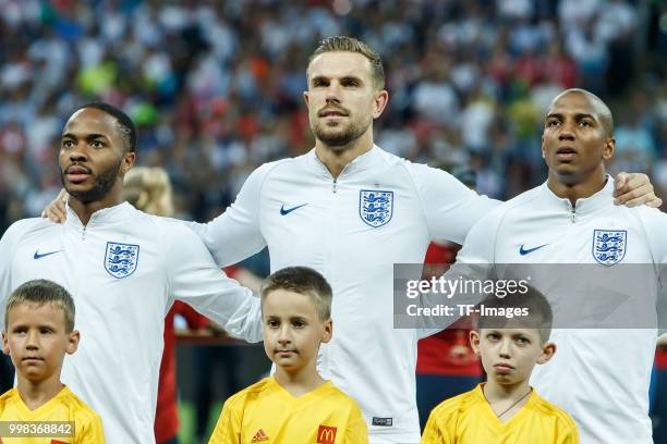 Raheem Sterling of England, Jordan Henderson of England and Ashley Young of England look on prior to the 2018 FIFA World Cup Russia Semi Final match...