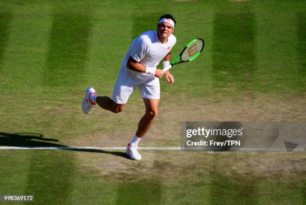 Milos Raonic of Canada in action against John Isner of the United States in the gentlemen's quarter finals at the All England Lawn Tennis and Croquet...