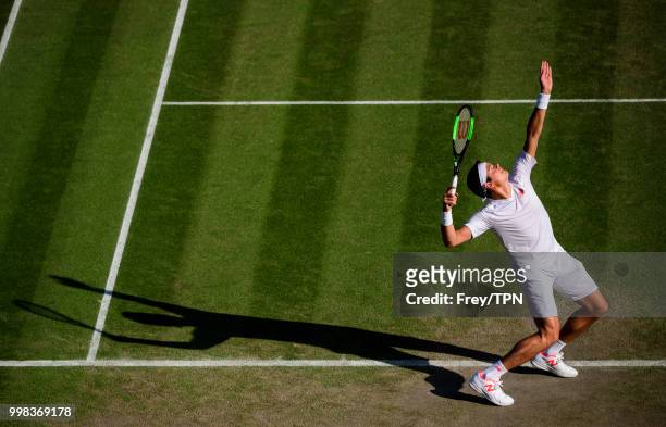 Milos Raonic of Canada in action against John Isner of the United States in the gentlemen's quarter finals at the All England Lawn Tennis and Croquet...
