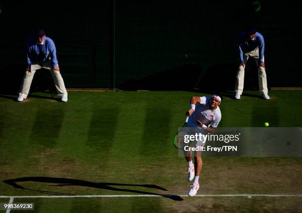 Milos Raonic of Canada in action against John Isner of the United States in the gentlemen's quarter finals at the All England Lawn Tennis and Croquet...