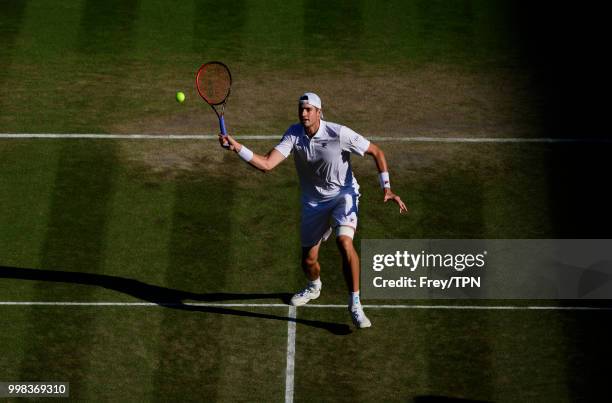 Milos Raonic of Canada in action against John Isner of the United States in the gentlemen's quarter finals at the All England Lawn Tennis and Croquet...