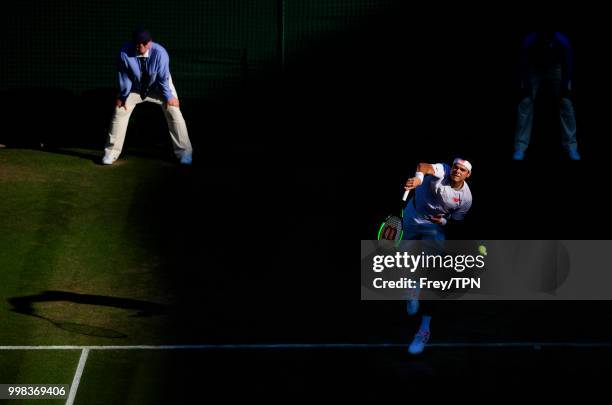 Milos Raonic of Canada in action against John Isner of the United States in the gentlemen's quarter finals at the All England Lawn Tennis and Croquet...