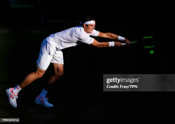 Milos Raonic of Canada in action against John Isner of the United States in the gentlemen's quarter finals at the All England Lawn Tennis and Croquet...