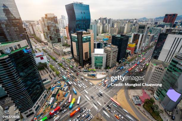 sunset scene of light trails traffic speeds through an intersection in gangnam center business district of seoul at seoul city, south korea. - kangnamgu stock pictures, royalty-free photos & images