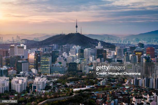 sunrise scene of seoul downtown city skyline, aerial view of n seoul tower at namsan park in twilight sky in morning. the best viewpoint and trekking from inwangsan mountain in seoul city, south korea - korea stockfoto's en -beelden