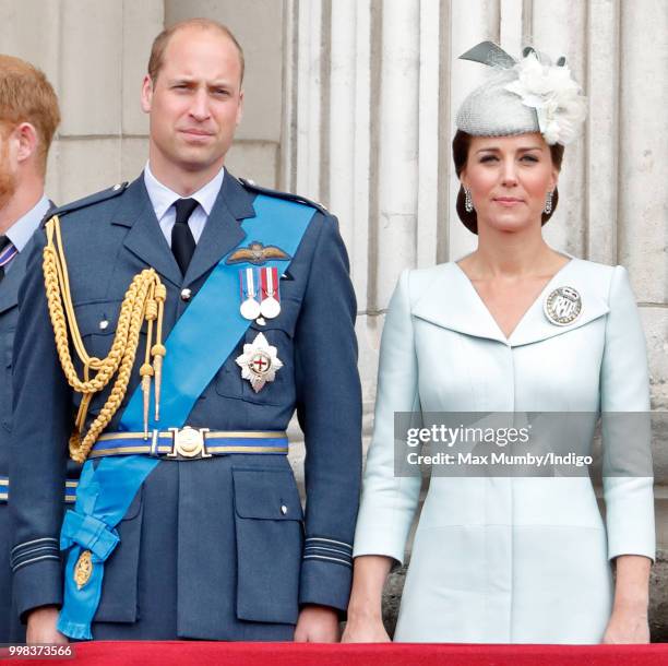 Prince William, Duke of Cambridge and Catherine, Duchess of Cambridge watch a flypast to mark the centenary of the Royal Air Force from the balcony...