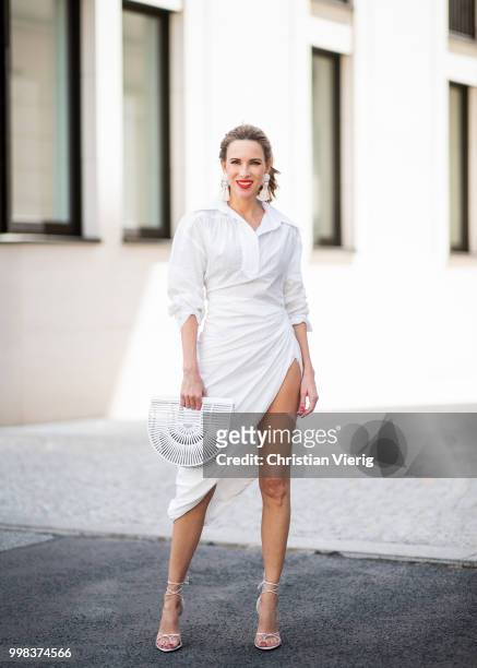 Alexandra Lapp is seen wearing La robe Amadora dress in white by Jacquemus, white Inez leather sandals by Saint Laurent, white Gaia's Ark bag by Cult...