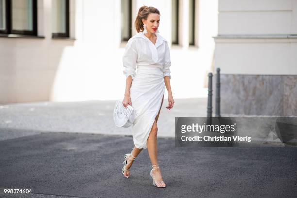 Alexandra Lapp is seen wearing La robe Amadora dress in white by Jacquemus, white Inez leather sandals by Saint Laurent, white Gaia's Ark bag by Cult...