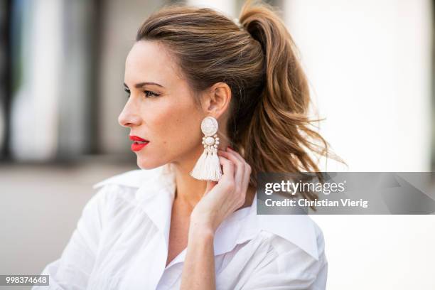 Alexandra Lapp is seen wearing La robe Amadora dress in white by Jacquemus, white Inez leather sandals by Saint Laurent, white Gaia's Ark bag by Cult...