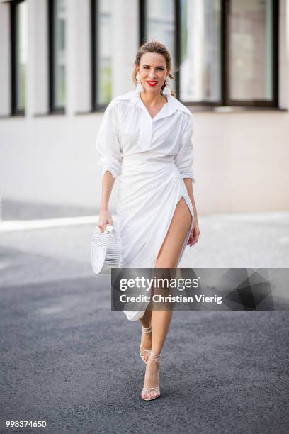 Alexandra Lapp is seen wearing La robe Amadora dress in white by Jacquemus, white Inez leather sandals by Saint Laurent, white Gaia's Ark bag by Cult...