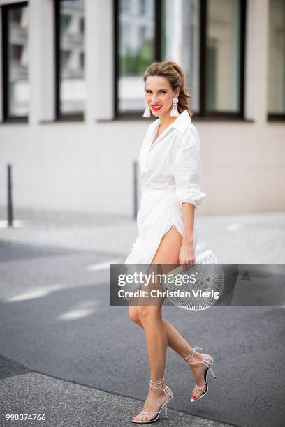 Alexandra Lapp is seen wearing La robe Amadora dress in white by Jacquemus, white Inez leather sandals by Saint Laurent, white Gaia's Ark bag by Cult...