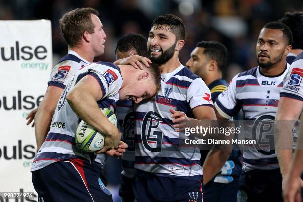 Reece Hodge of the Rebels celebrates his try with team-mates during the round 19 Super Rugby match between the Highlanders and the Rebels at Forsyth...