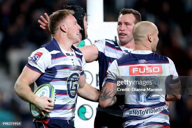 Reece Hodge of the Rebels celebrates his try with team-mates during the round 19 Super Rugby match between the Highlanders and the Rebels at Forsyth...