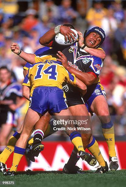 Ali Lauitiiti for New Zealand is tackled by the Eels defence during the NRL fourth qualifying final match played between the Parramatta Eels and the...