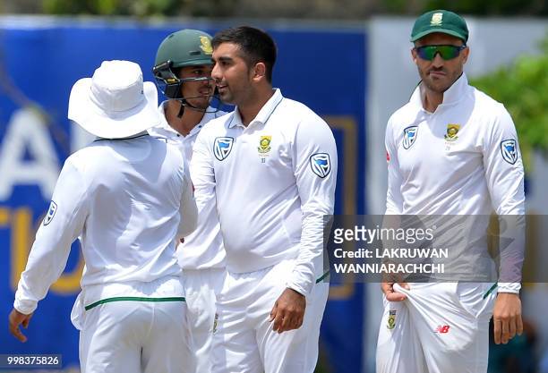 South Africa's Tabraiz Shamsi celebrates with his teammates after he dismissed Sri Lanka's Rangana Herath during the third day of the opening Test...
