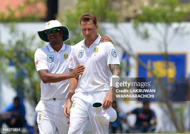 South Africa's Dale Steyn is congratulated by his teammate Vernon Philander after dismissing Sri Lanka's Lakshan Sandakan during the third day of the...