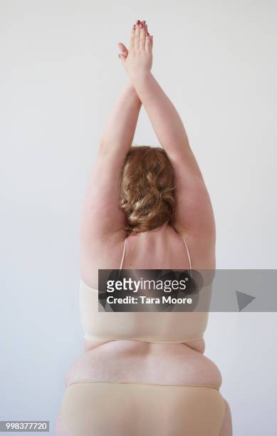 curvy woman stretching - voluptuous body stock pictures, royalty-free photos & images