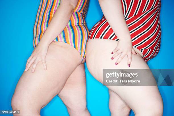 two curvy woman leaning on each other - woman with big legs stock pictures, royalty-free photos & images